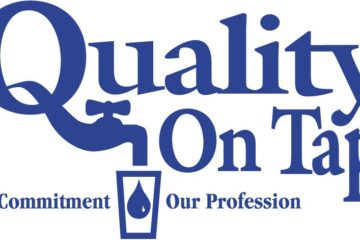 The logo of quality on top in blue with white background