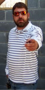 A person wearing white shirt pointing towords the camera
